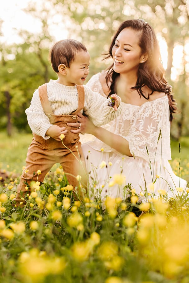 mommy and boy on wildflowers field during sunset in spring in Boston