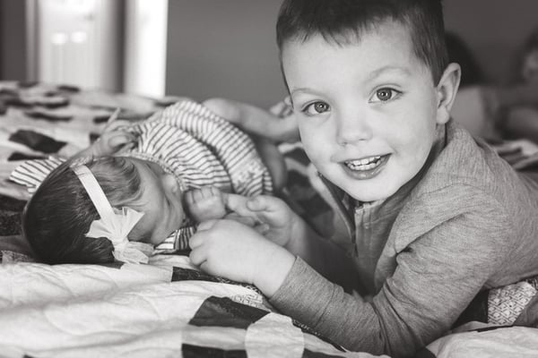 Siblings love to hold, kiss and hug the baby!