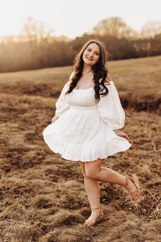 High School senior girl dancing with an autumn field, at Lexington, MA