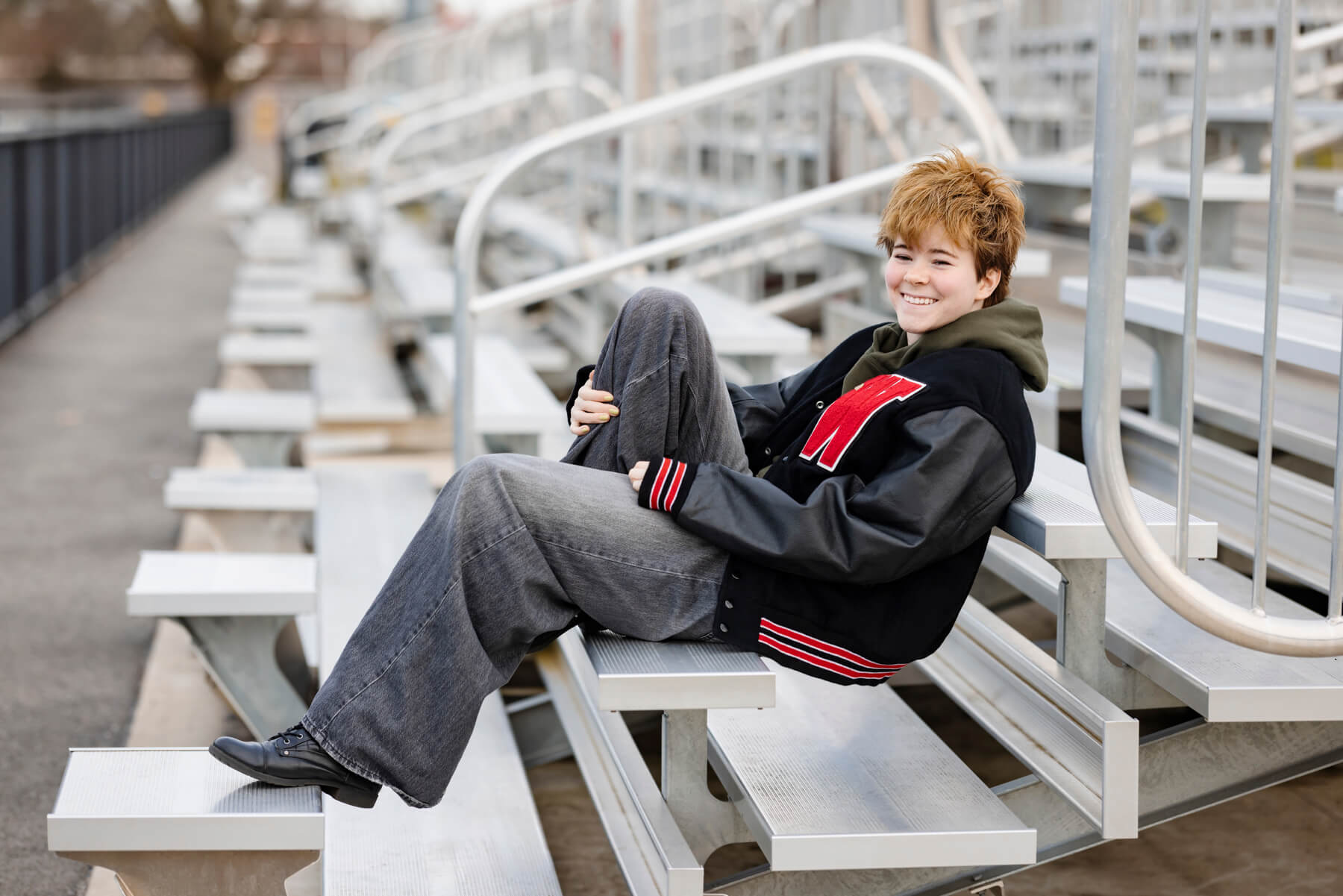high school Senior boy sitting on the school stadium stands, at Lexington, MA