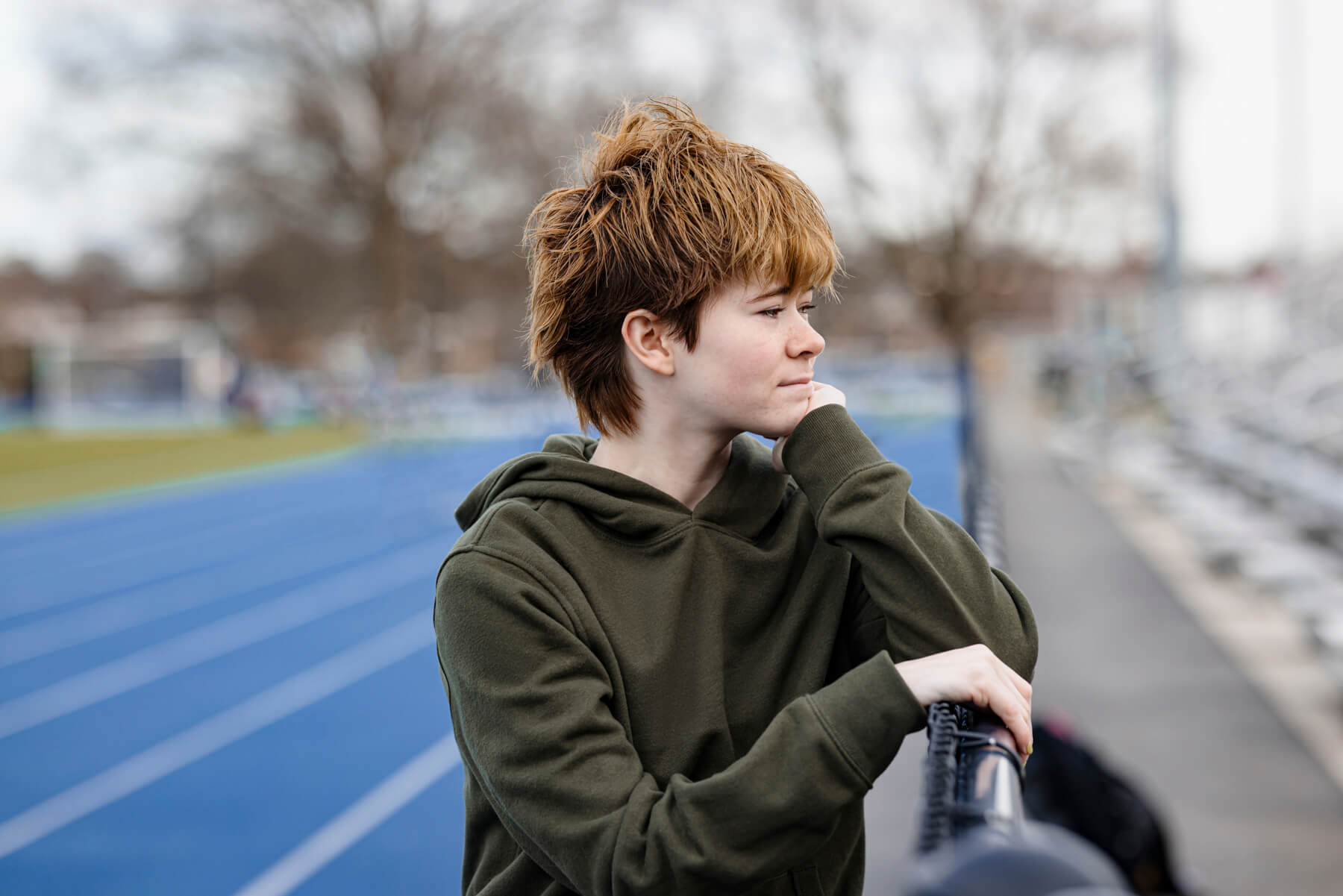 High school Senior trans boy in field track, at Lexington, Massachusetts