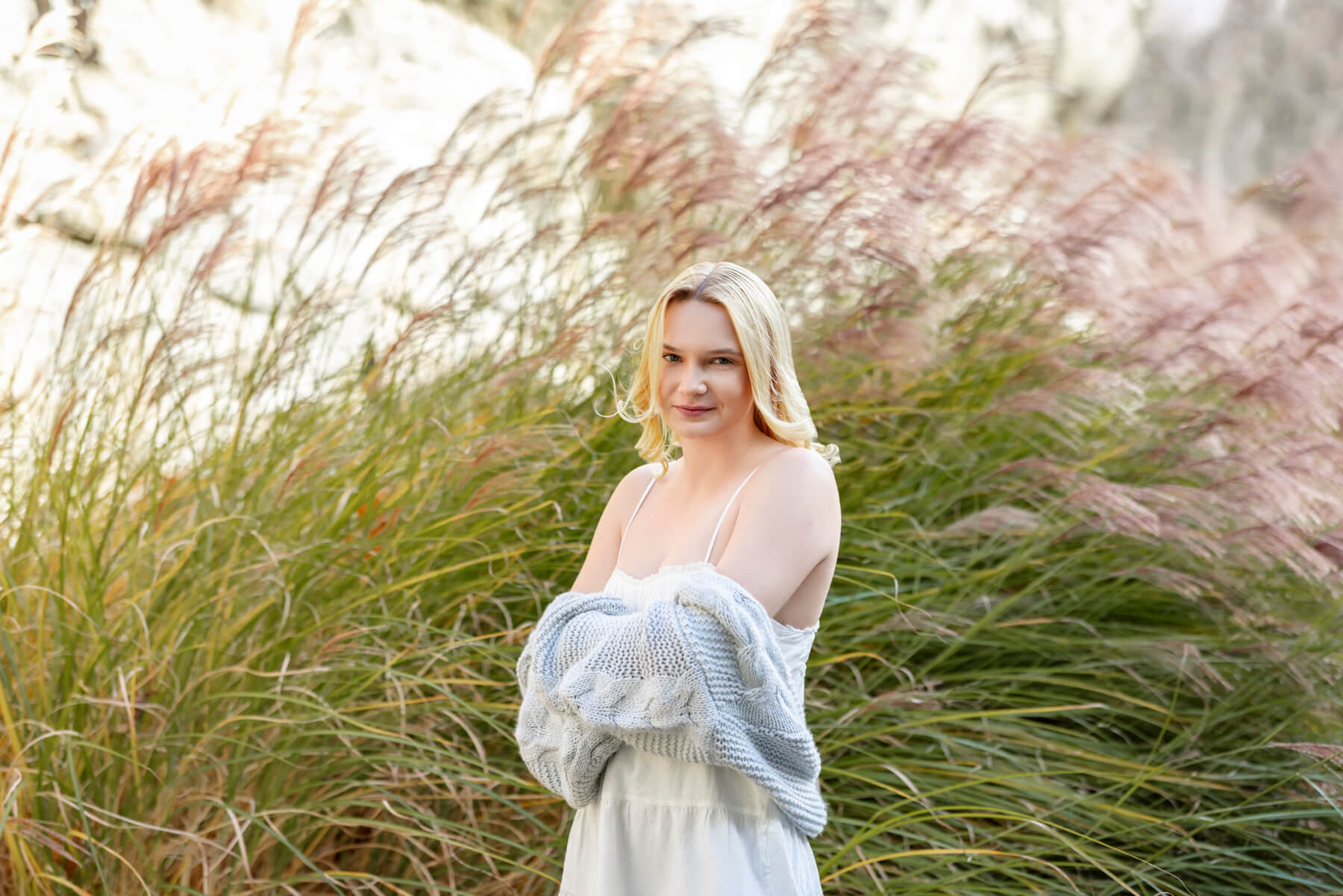 High School senior girl posing with bushes behind, at Lexington, MA