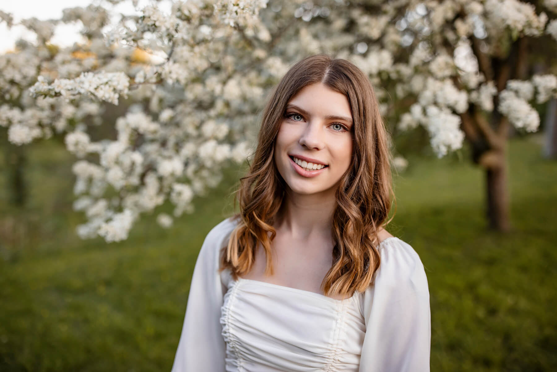 Senior photo-3High School senior girl posing with white flowers tree behind, at Lexington, MA