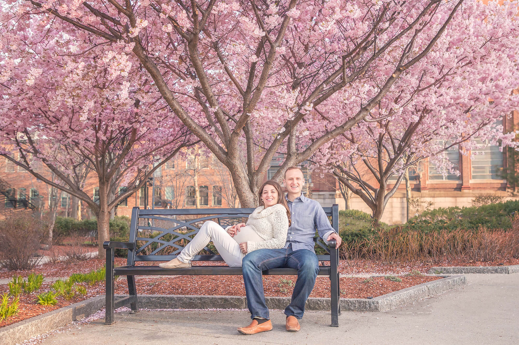 Spring - Boston maternity photo with cherry blossoms, mom in white jeans