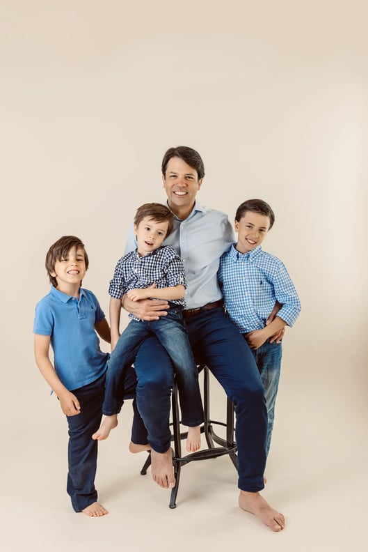a studio photo of a father and his sons in Boston